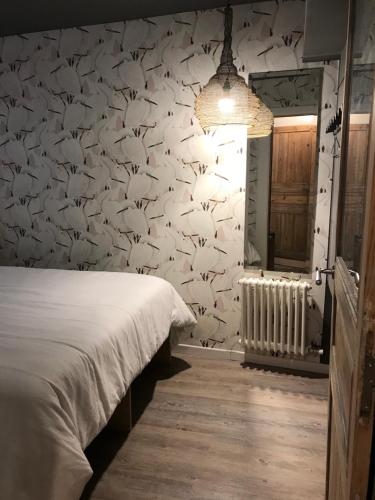 a bedroom with a bird patterned wall with a bed at donibane 20 Orduña in Orduña