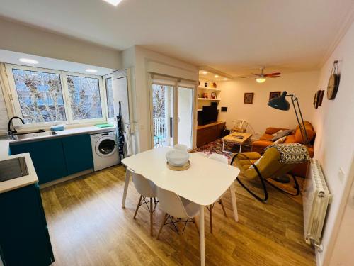 a kitchen and living room with a table and chairs at Itsasoa by Basque Homes in Donostia-San Sebastián