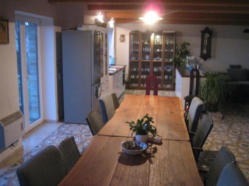 a kitchen with a long wooden table and chairs at Chata U Jirky 