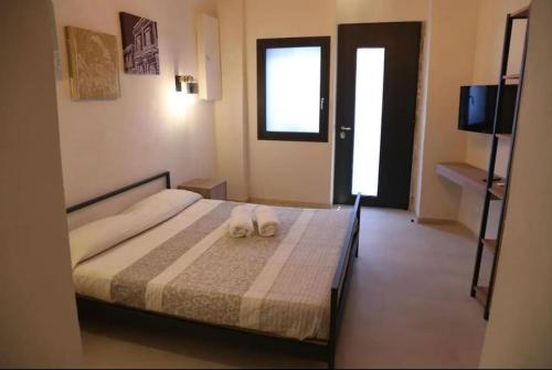 a bedroom with a bed with two shoes on it at Locus Pendinelli Trani in Trani