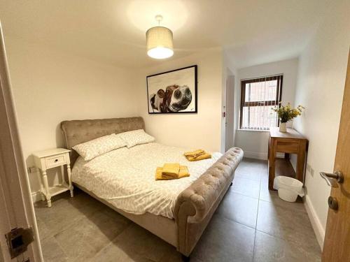 a bedroom with a bed and a couch in it at Boutique Style Apartment Belfast in Belfast