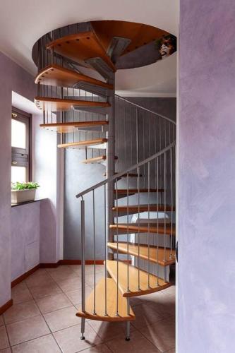 a wooden spiral staircase in a room at Alex Haus in Somma Lombardo