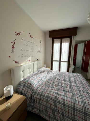 a bedroom with a bed with a plaid comforter at Blue Lagoon Home in Sulzano