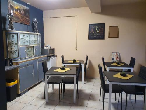 a restaurant with tables and chairs in a room at Panzio A mi Paradicsomunk in Véménd