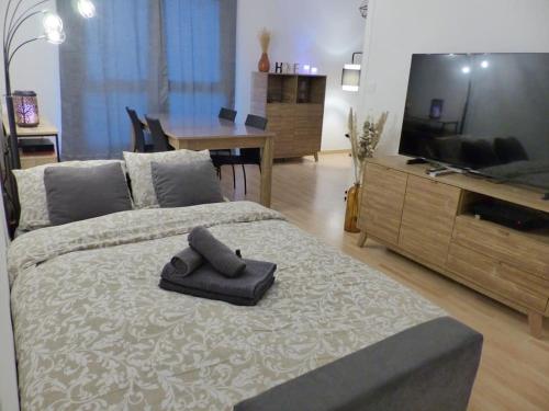 - une chambre avec un lit, une télévision et une table dans l'établissement VULCAIN 4, 14ème, Ile de Nantes, vue exceptionnelle avec parking, à Nantes