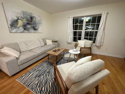 a living room with a couch and a table at Great Value Close to Proctors Gorgeous Townhouse in Schenectady