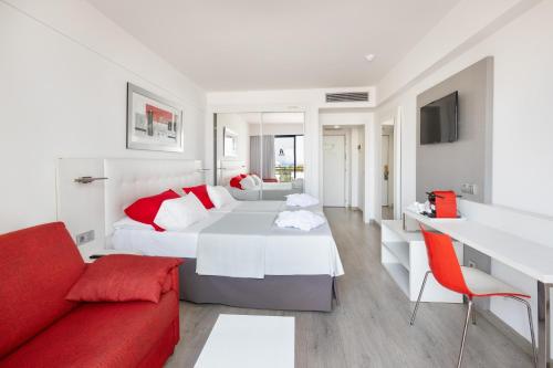 a bedroom with a large bed and a red couch at Alexandre Hotel Gala in Playa de las Americas