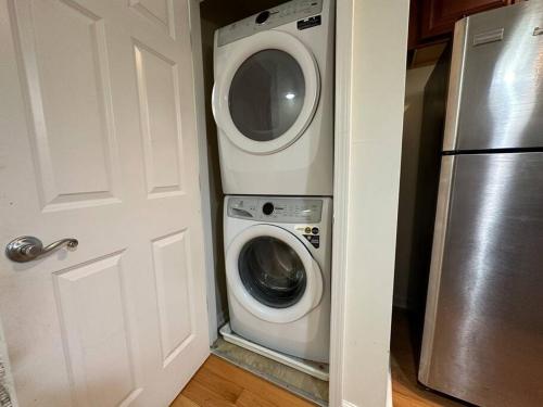 a washer and dryer in a kitchen next to a door at Great Value Close to Proctors Gorgeous Townhouse in Schenectady