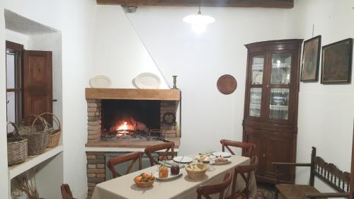 a dining room with a table and a fireplace at Casa Camboni-Dimora Storica Bed & Breakfast in San Vito