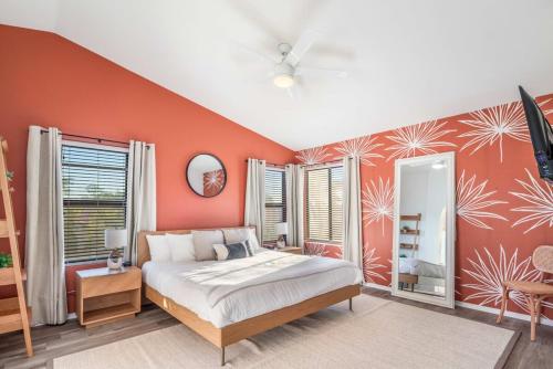 a bedroom with orange walls and a bed in it at Peoria Paradise Sportscourt Heated Pool Gameroom in Peoria
