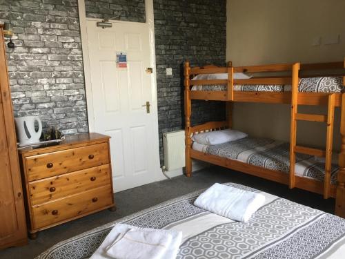 a bedroom with two bunk beds and a dresser at Royal Hotel in Blackpool