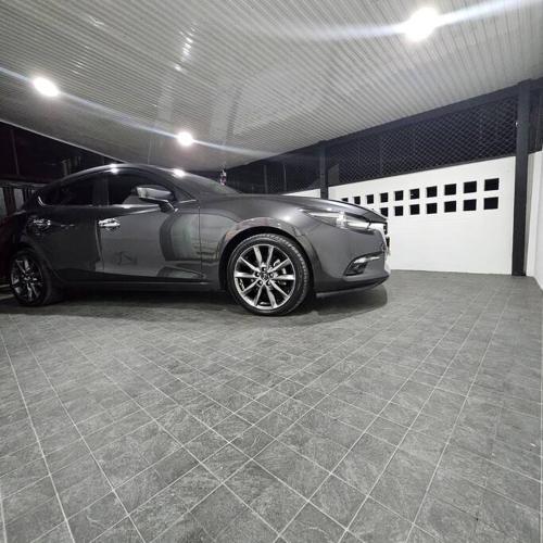 a silver car parked in a garage at 52PrivateHouse บ้านพักส่วนตัว ใจกลางเมือง Free Netflix & Youtube premium in Lampang
