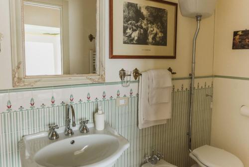 a bathroom with a sink and a toilet and a mirror at The Perfect Place in Ravenna