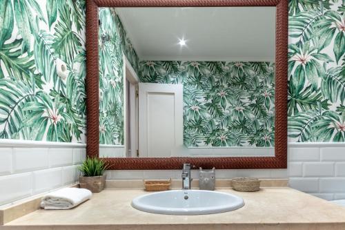 a bathroom with a sink and a mirror at Arkotxa apartment by People Rentals in Getxo