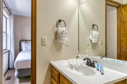 a bathroom with a sink and a mirror at Pool- Pinecrest Townhomes-1King-2Queen Unit-Updated in Pigeon Forge