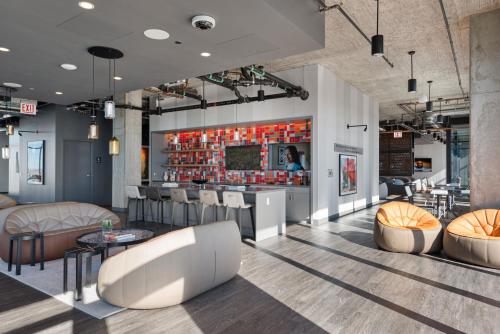 a lobby with chairs and a bar in a building at Fulbrix Bright Designer Apartments with West Loop Views in Chicago