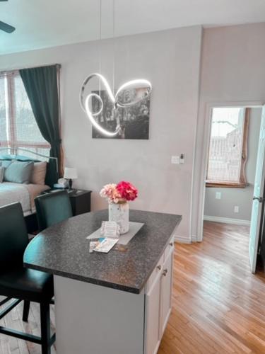 a kitchen with a counter with a vase of flowers on it at Etherington Suites in Elora