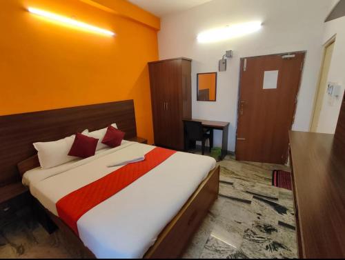 a bedroom with a bed and a desk in it at Hotel New Cresent park in Coimbatore