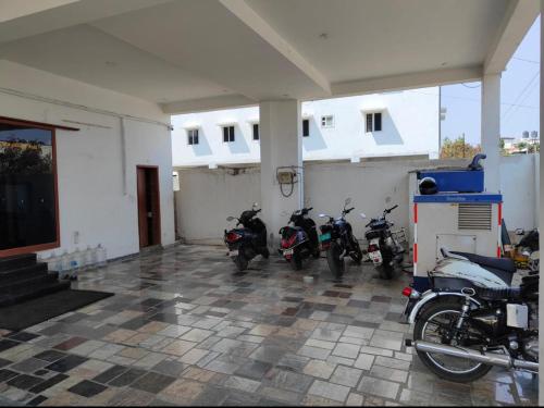 a group of motorcycles parked in a garage at Hotel New Cresent park in Coimbatore