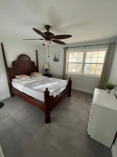 a bedroom with a bed and a ceiling fan at Cozzy Apartment on the Caribbean side-Frigate Bay in Frigate Bay