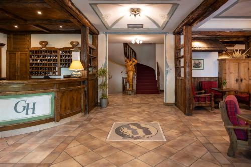 a large room with a lobby with a staircase at Golf Hotel in Folgaria