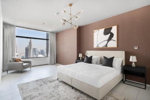 a bedroom with a white bed and a large window at Silkhaus contemporary 1BDR with Downtown view in DIFC in Dubai