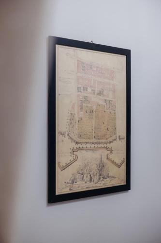 a framed picture of a building on a wall at Palazzo Dalla Rosa Prati in Parma