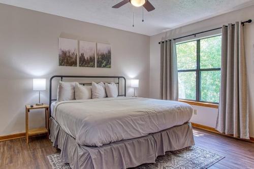 a bedroom with a large bed and a window at Pool-Pinecrest Townhomes-Two Units-Dollywood-Renovated in Pigeon Forge