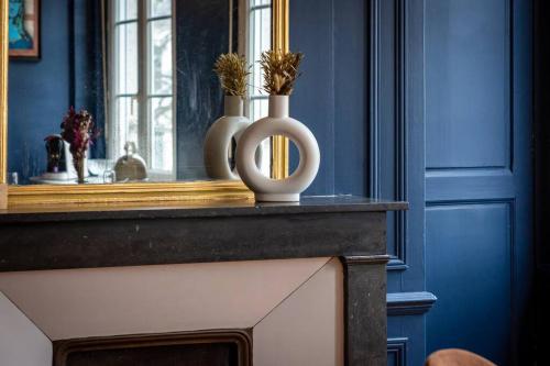 une chambre bleue avec une table et un vase sur elle dans l'établissement Appartement balnéo centre, à Rouen