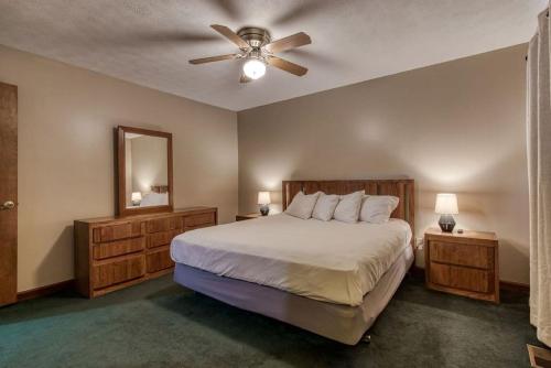 a bedroom with a bed and a ceiling fan at Pool-Pinecrest Townhomes-1King-2Queen Unit in Pigeon Forge