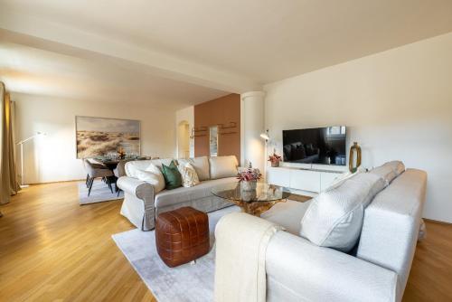 a living room with a couch and a table at 5-bedroom luxury retreat by Charles Bridge in Prague