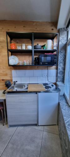 a kitchen with a sink and a counter top at La Petite Maison à Jupille in Liège