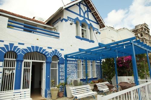 a blue and white house with blue accents at Pousada Areia da Praia in Fortaleza