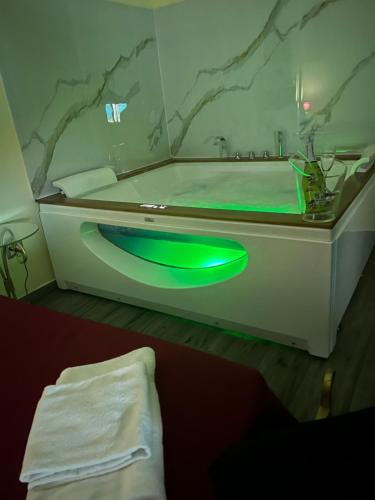 a bathroom with a tub with a green sink at Duca di Uzeda Bed & Breakfast Luxury and Style in Catania