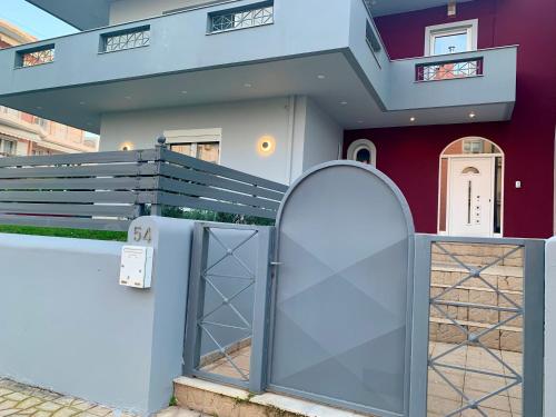 a house with a gate in front of a building at Mint Luxury Residence in Spáta