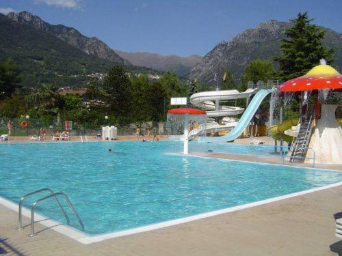 a swimming pool with a slide and a water park at Mobile Home Italy in Porlezza
