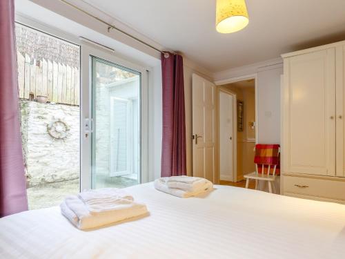 a bedroom with a bed and a large window at 2 Bed in Brixham 80008 in Brixham