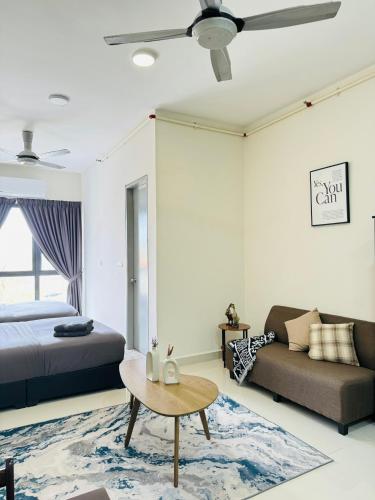 a bedroom with a bed and a couch and a table at CoreSoho Suite by BKAstaycation KotaWarisan Sepang KLIA Airport, Free Wifi in Sepang