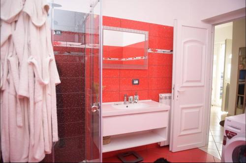 a bathroom with a sink and a glass shower at Hotel Villa Linda in Shkodër