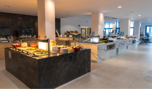 a kitchen with a buffet of food on a counter at Kamari Beach in Lardos