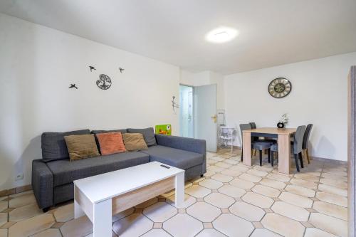 un salon avec un canapé et une table dans l'établissement F2 coquet à Disney-Parking-WIFI, à Bussy-Saint-Georges