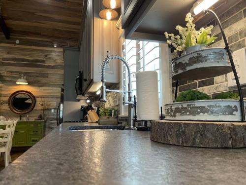 a kitchen with a sink and a counter top at Elegant Country Cottage in Caldwell Crossing