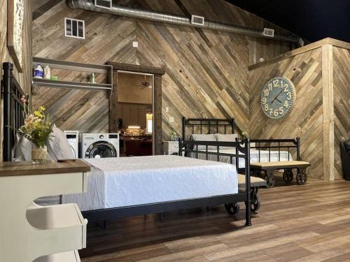 a bedroom with a bed and a clock on a wall at Elegant Country Cottage in Caldwell Crossing