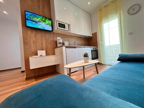 a room with a bed and a tv on a wall at Relax Apartment II in Perea