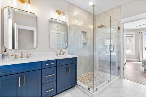 a bathroom with two sinks and a shower at Coastal Charm Ocean Isle Beach custom beach home with 4 bedroom, 3 bath home with pool and elevator in Ocean Isle Beach