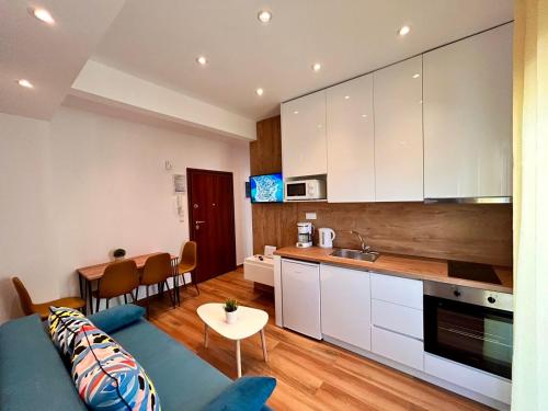 a kitchen and living room with a couch and a table at Relax Apartment II in Perea