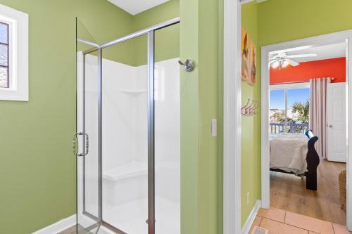 a walk in shower in a room with green walls at Cherry Bomb Private heated Pool, Elevator in Ocean Isle Beach