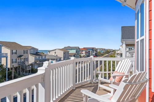 two chairs on a balcony with a view of the ocean at Cherry Bomb Private heated Pool, Elevator in Ocean Isle Beach