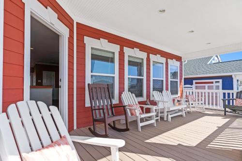 a deck with chairs and a table on a house at Cherry Bomb Private heated Pool, Elevator in Ocean Isle Beach