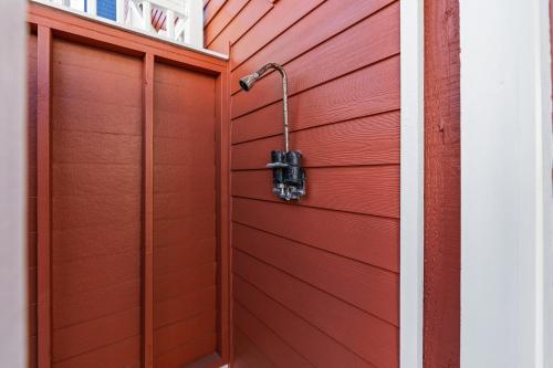 a red garage door with a shower at Cherry Bomb Private heated Pool, Elevator in Ocean Isle Beach